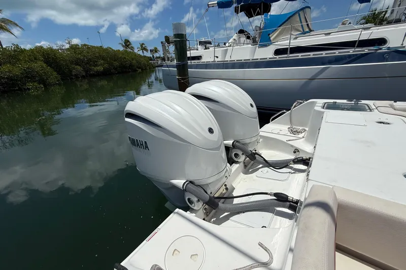 Afterthought Yacht Photos Pics 2022 Sea Hunt Gamefish 30 with twin Yamaha outboard motors docked by a marina.