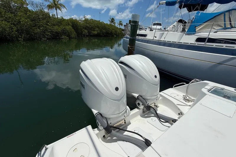 Afterthought Yacht Photos Pics Twin outboard engines on a 2022 Sea Hunt Gamefish 30 Coffin Box boat docked by mangroves.
