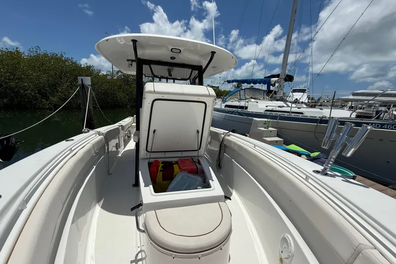 Afterthought Yacht Photos Pics 2022 Sea Hunt Gamefish 30 Coffin Box boat with open storage, docked under blue sky.