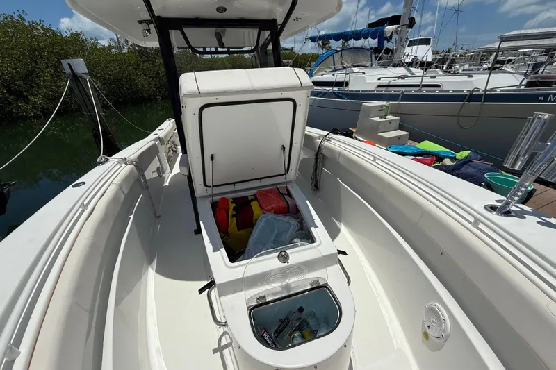 Afterthought Yacht Photos Pics 2022 Sea Hunt Gamefish 30 Coffin Box boat interior with open storage compartment.