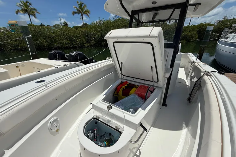 Afterthought Yacht Photos Pics 2022 Sea Hunt Gamefish 30 Coffin Box with open storage, docked near palm trees.