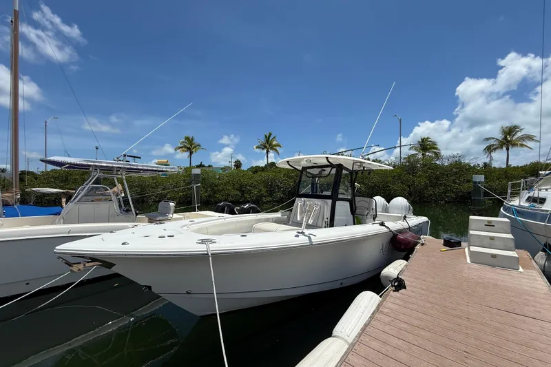 Afterthought Yacht Photos Pics 2022 Sea Hunt Gamefish 30 Coffin Box boat docked under clear blue sky.