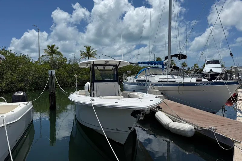 Afterthought Yacht Photos Pics 2022 Sea Hunt Gamefish 30 Coffin Box boat docked at marina under blue sky.