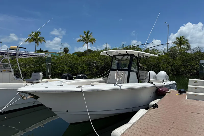 Afterthought Yacht Photos Pics 2022 Sea Hunt Gamefish 30 Coffin Box boat docked under clear blue sky.