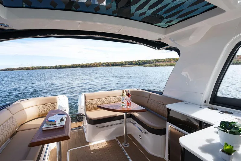 Yacht Photos Pics Interior of 2023 Sea Ray Sundancer 370 Outboard with lake view and seating area.