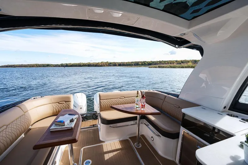  Yacht Photos Pics 2023 Sea Ray Sundancer 370 Outboard interior with lake view, featuring elegant seating and table.
