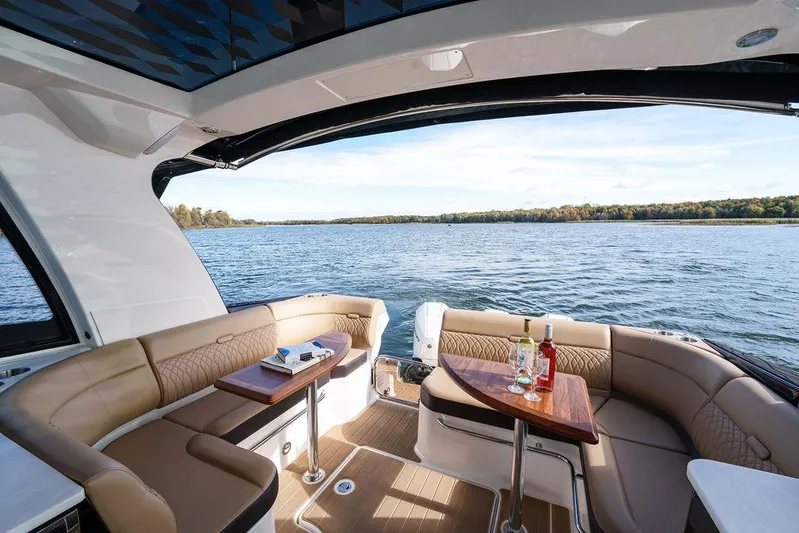  Yacht Photos Pics 2023 Sea Ray Sundancer 370 Outboard interior with lake view, featuring luxurious seating and tables.