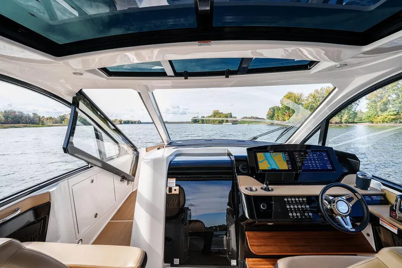  Yacht Photos Pics 2023 Sea Ray Sundancer 370 Outboard interior with modern dashboard and scenic water view.