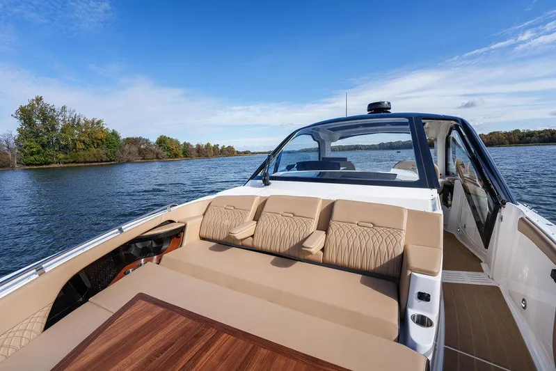  Yacht Photos Pics 2023 Sea Ray Sundancer 370 Outboard cruising on a serene lake with plush seating.