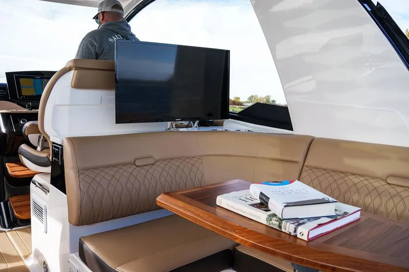  Yacht Photos Pics Interior of 2023 Sea Ray Sundancer 370 Outboard with seating, table, and TV.