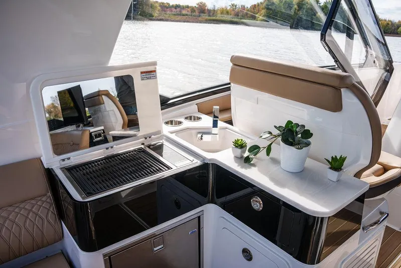  Yacht Photos Pics 2023 Sea Ray Sundancer 370 Outboard interior with grill and sink, featuring modern design.