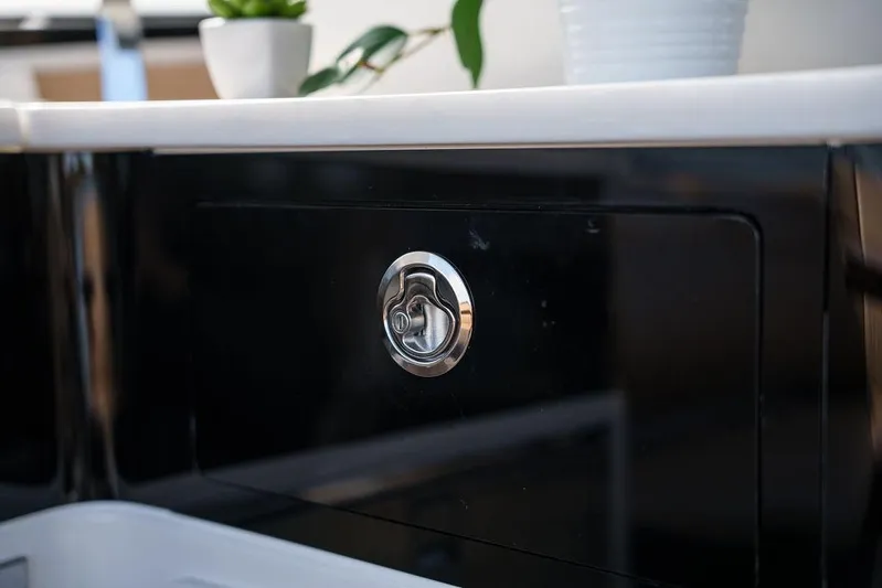  Yacht Photos Pics 2023 Sea Ray Sundancer 370 Outboard interior detail with sleek black cabinetry and chrome handle.