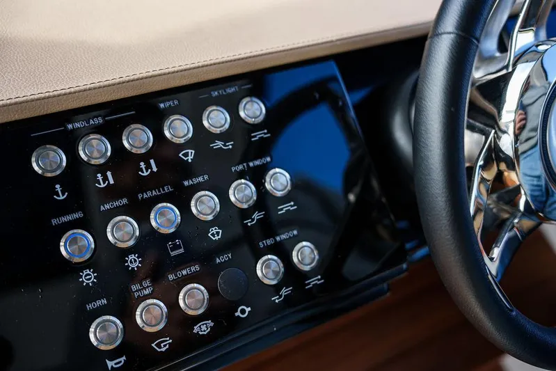  Yacht Photos Pics Control panel of 2023 Sea Ray Sundancer 370 Outboard with various buttons and steering wheel.