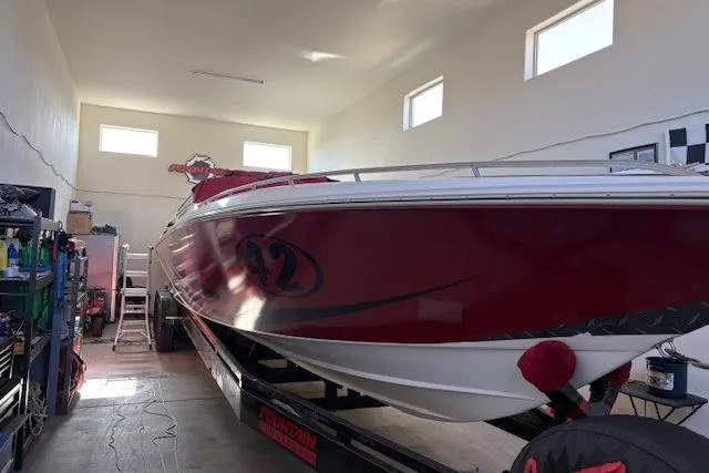  Yacht Photos Pics 2006 Fountain 42 Lightning speedboat in a garage, red and white design.