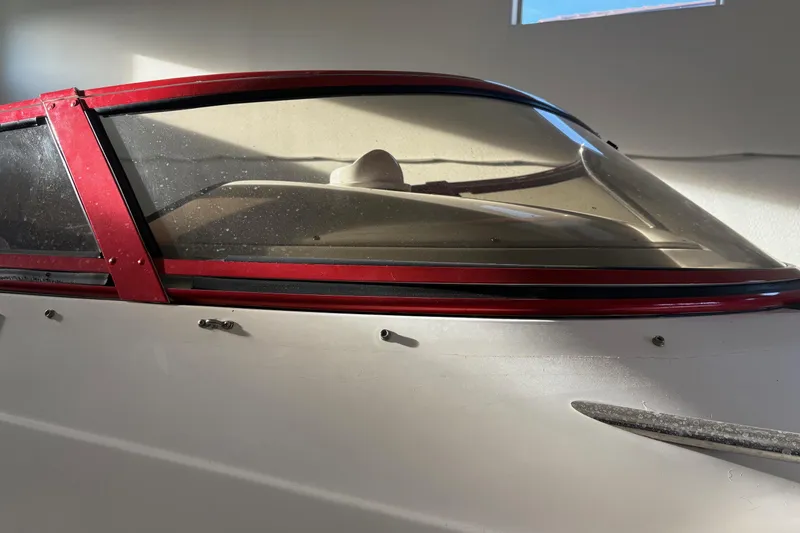  Yacht Photos Pics 2006 Fountain 42 Lightning boat with red trim and windshield in a garage.