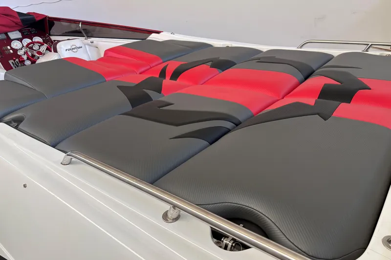  Yacht Photos Pics 2006 Fountain 42 Lightning boat interior with red and gray cushioned seating.