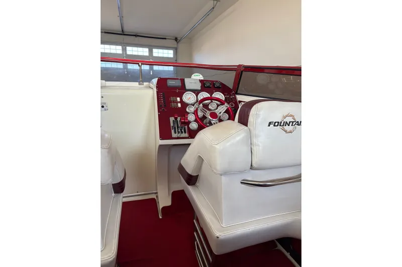  Yacht Photos Pics 2006 Fountain 42 Lightning boat cockpit with red dashboard and white seating.