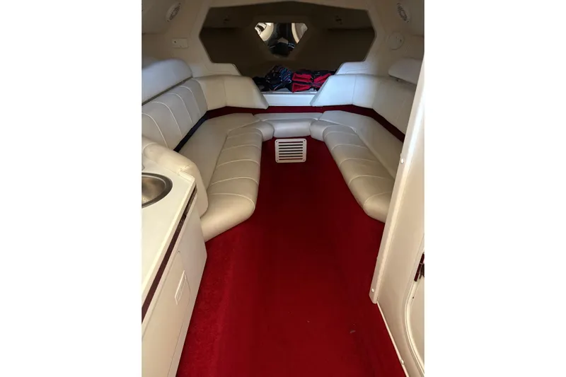  Yacht Photos Pics Interior of 2006 Fountain 42 Lightning boat with red carpet and white seating.