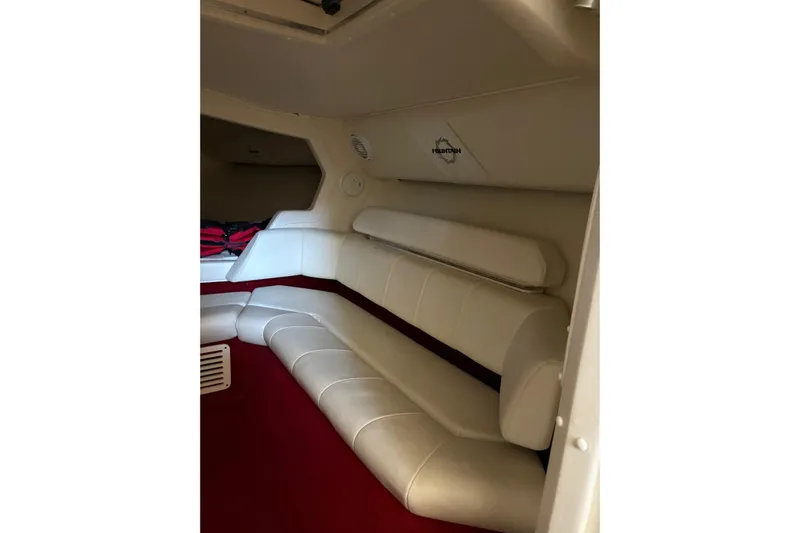  Yacht Photos Pics Interior of 2006 Fountain 42 Lightning boat with white seating and red carpet.