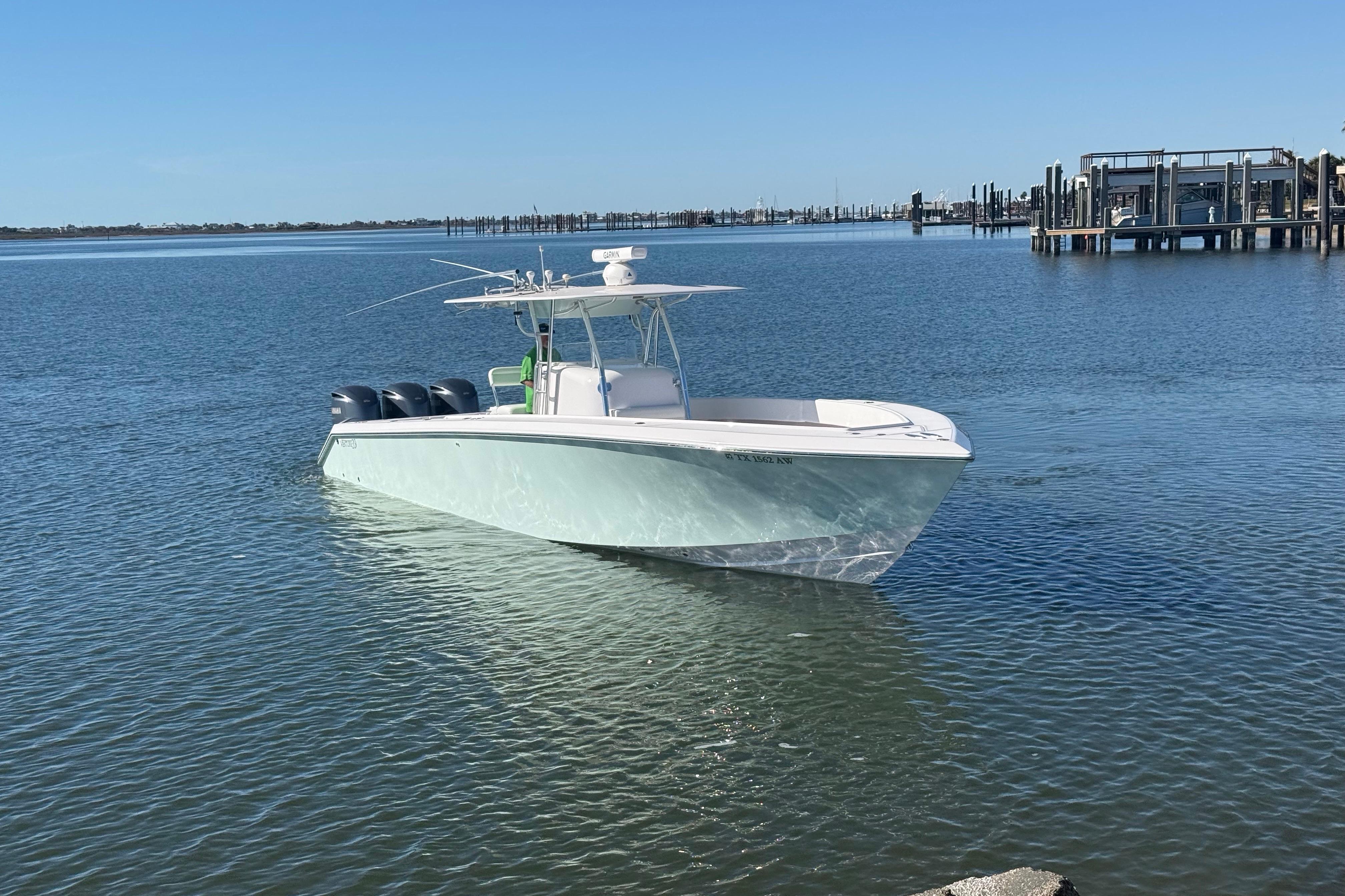 2009 Venture 39 Open boat on calm water near a marina.