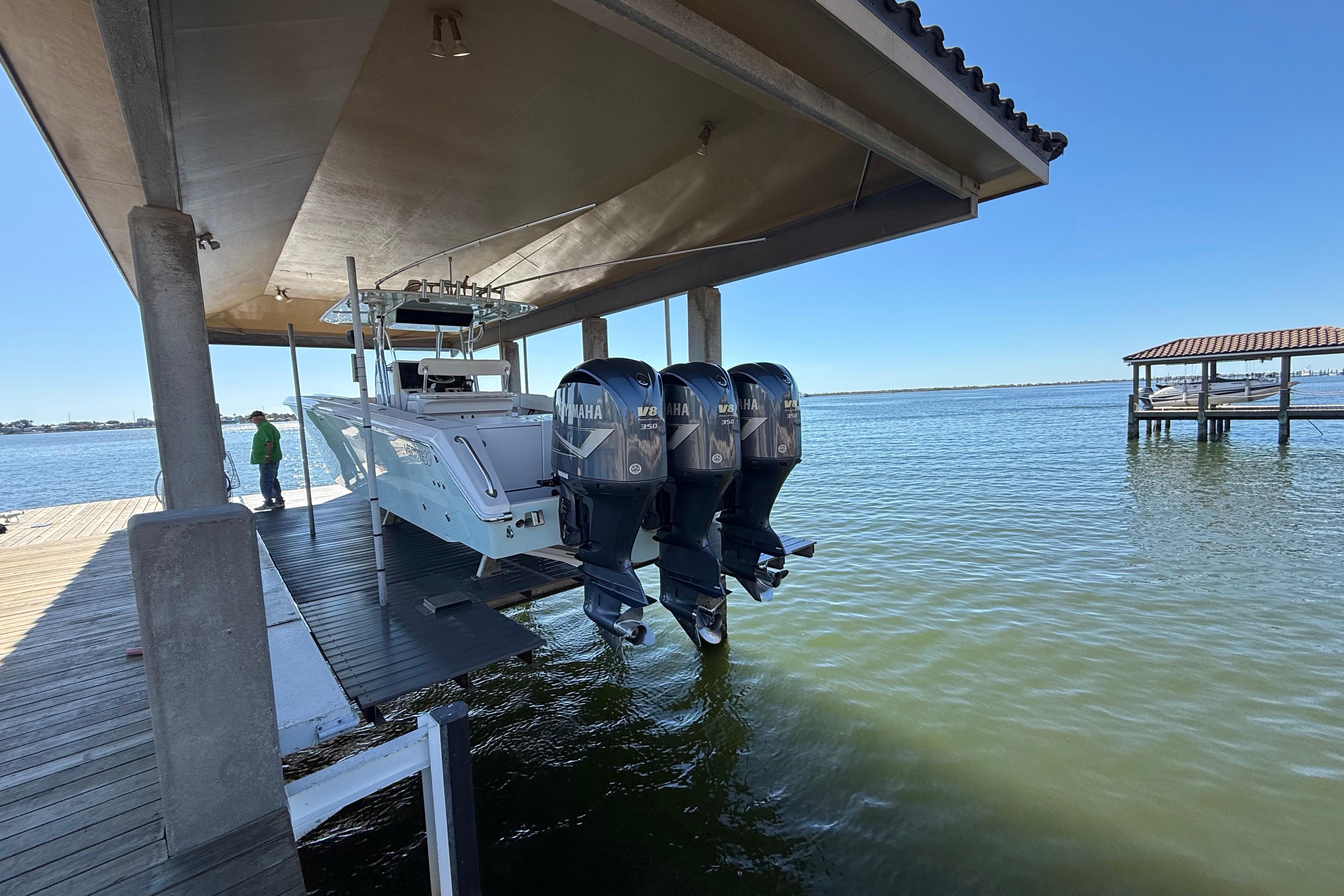 2009 Venture 39 Open boat with triple Yamaha engines on a dock lift.