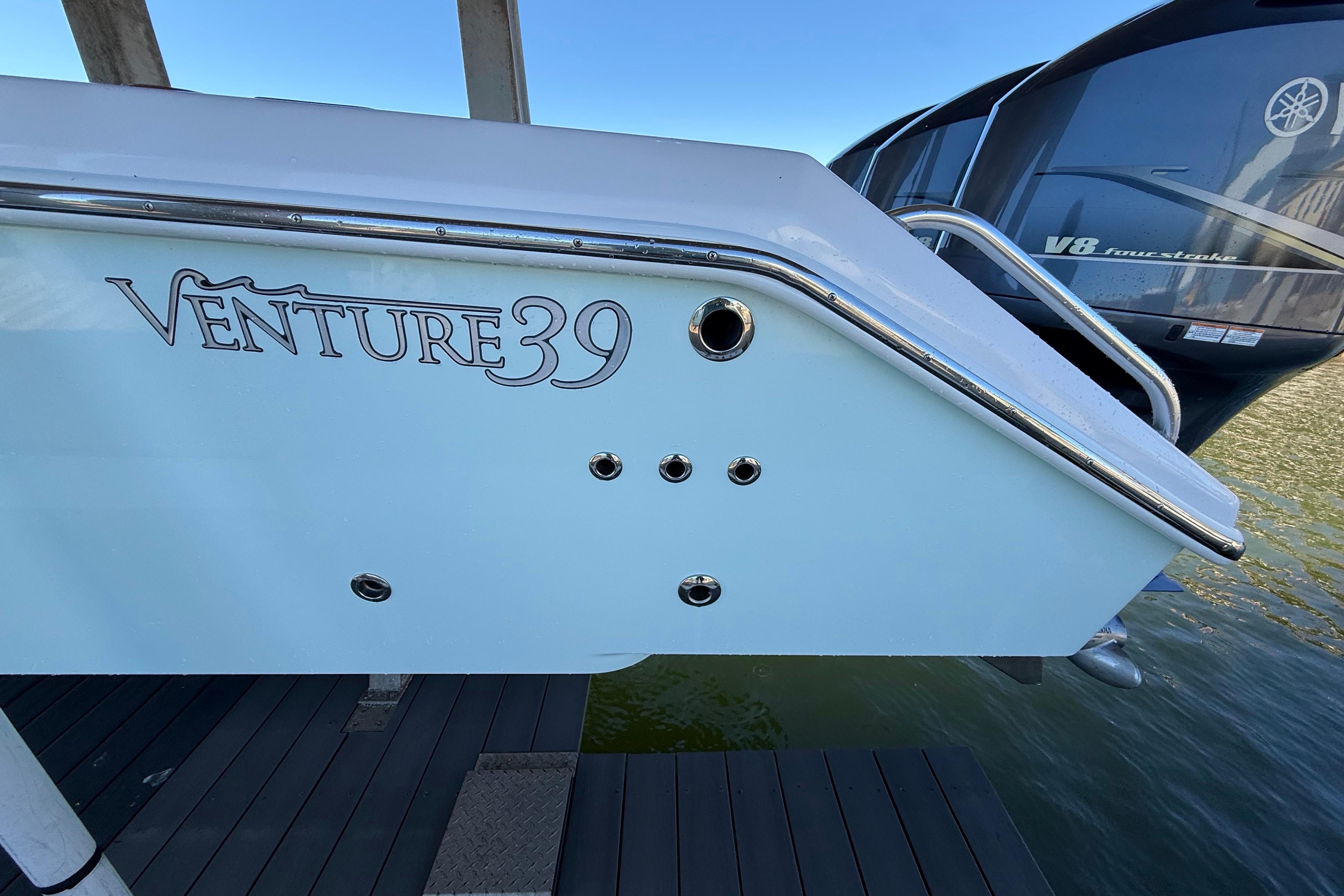2009 Venture 39 Open boat stern with logo and Yamaha V8 engine.