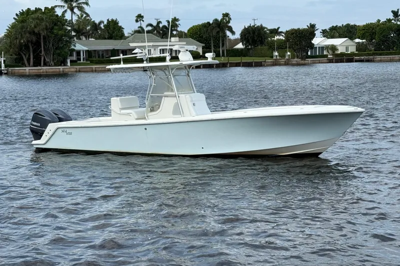  Yacht Photos Pics 2013 SeaVee 320B boat on calm water, featuring twin outboard engines.