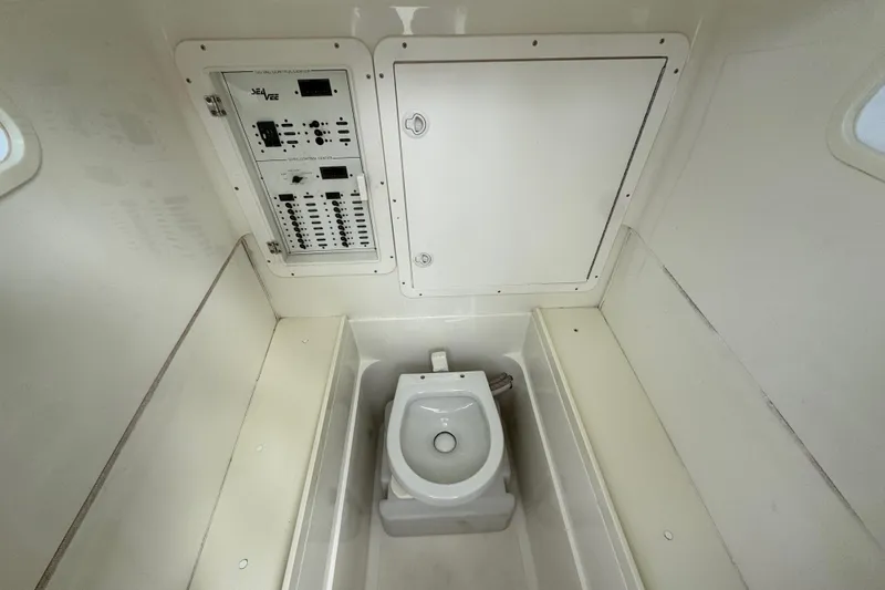  Yacht Photos Pics 2013 SeaVee 320B boat interior with control panel and marine toilet.