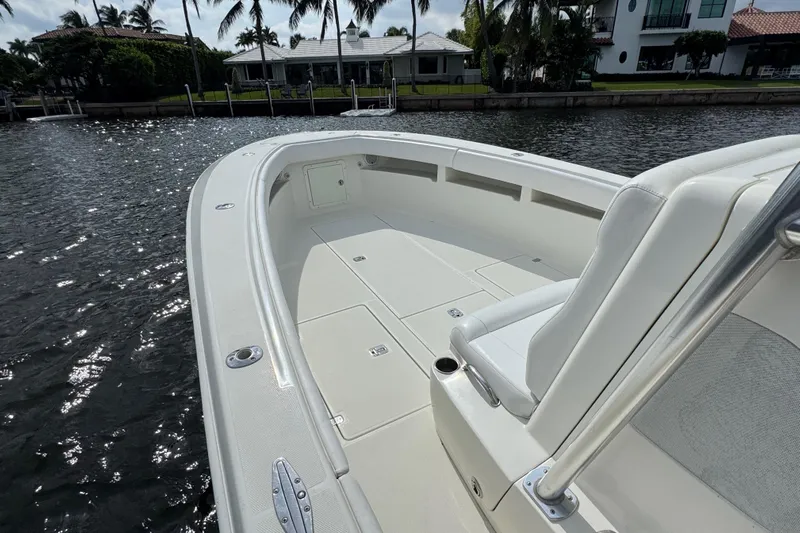  Yacht Photos Pics 2013 SeaVee 320B boat with spacious deck, docked by waterfront homes.