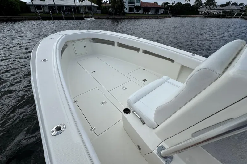  Yacht Photos Pics 2013 SeaVee 320B boat interior with white seating and storage compartments on calm water.