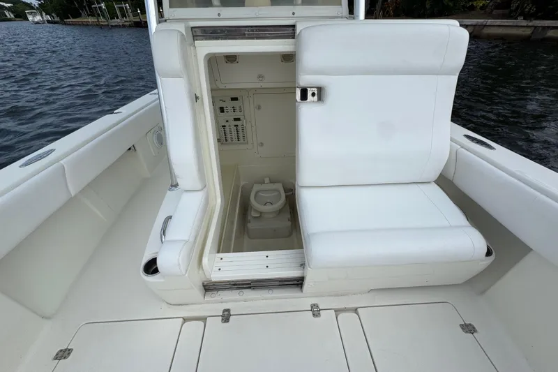  Yacht Photos Pics 2013 SeaVee 320B boat with open storage compartment and seating, dockside view.