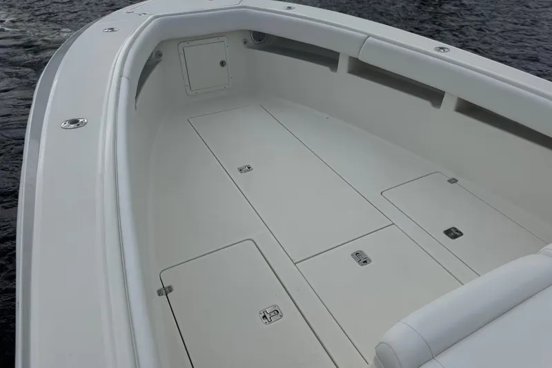  Yacht Photos Pics 2013 SeaVee 320B boat deck with storage compartments on calm water.