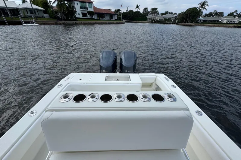  Yacht Photos Pics 2013 SeaVee 320B boat with dual engines, rod holders, and a scenic waterfront view.