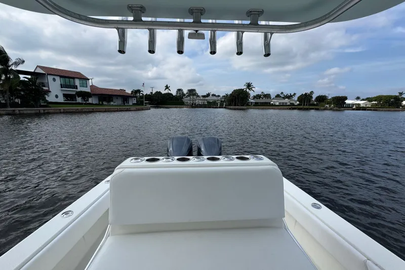  Yacht Photos Pics 2013 SeaVee 320B boat on calm water, with waterfront homes in the background.