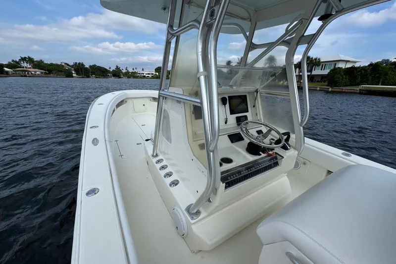  Yacht Photos Pics 2013 SeaVee 320B boat interior with steering console on calm water.