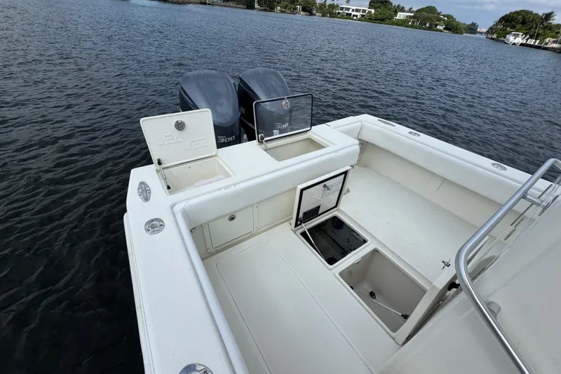  Yacht Photos Pics 2013 SeaVee 320B boat with open storage compartments and twin engines on a calm waterway.