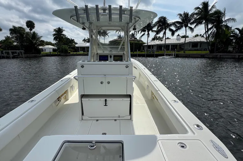  Yacht Photos Pics 2013 SeaVee 320B boat on calm water, surrounded by palm trees and waterfront homes.