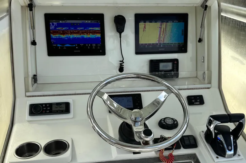  Yacht Photos Pics 2013 SeaVee 320B boat dashboard with steering wheel, dual displays, and controls.