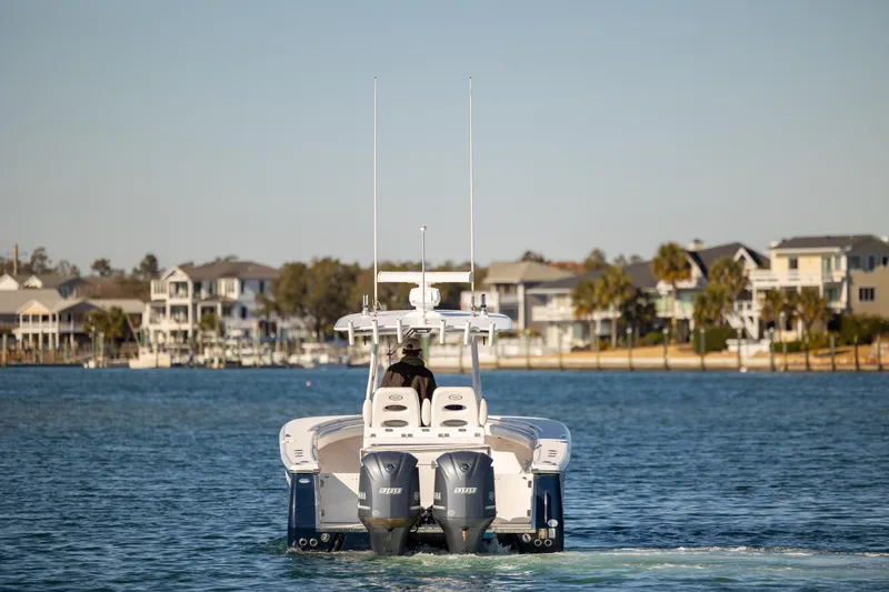 Seachosis Yacht Photos Pics 2014 Southport 29TE boat cruising on a calm waterway near coastal homes.