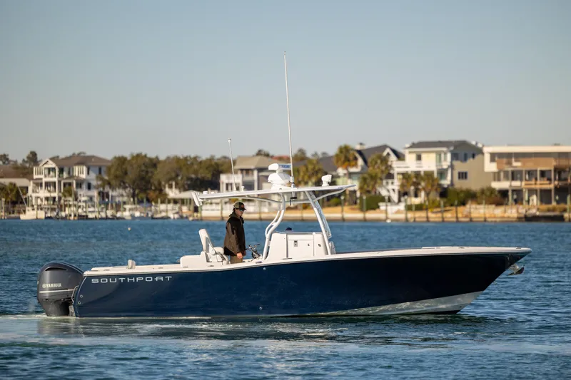 Seachosis Yacht Photos Pics 2014 Southport 29TE boat cruising on a calm waterway near waterfront homes.