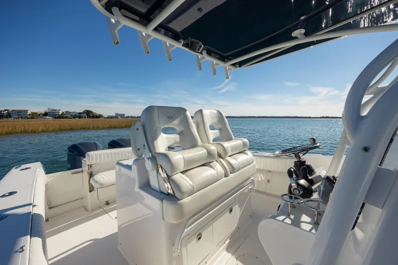 Seachosis Yacht Photos Pics 2014 Southport 29TE boat interior with dual seats, steering console, and scenic water view.
