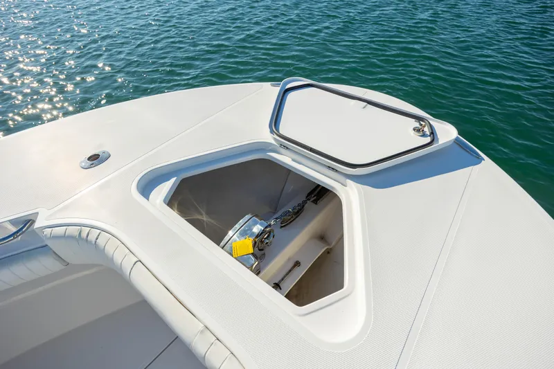 Seachosis Yacht Photos Pics 2014 Southport 29TE boat with open storage compartment on deck, floating on water.