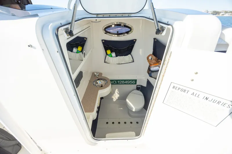 Seachosis Yacht Photos Pics Interior cabin of 2014 Southport 29TE boat, featuring compact amenities and storage.