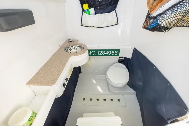 Seachosis Yacht Photos Pics 2014 Southport 29TE boat interior with compact bathroom and storage.