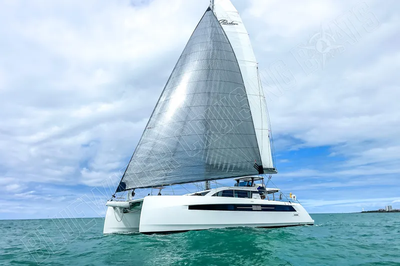 Fun Pass Yacht Photos Pics Sailing catamaran Privilege 580, 2025 model, cruising on open sea under cloudy skies.