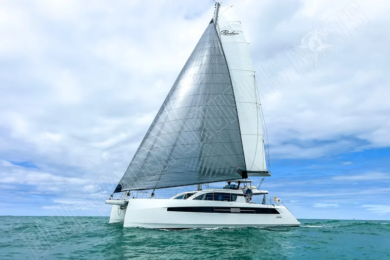 Fun Pass Yacht Photos Pics Sailing catamaran Privilege 580, 2025 model, cruising on open sea under cloudy sky.