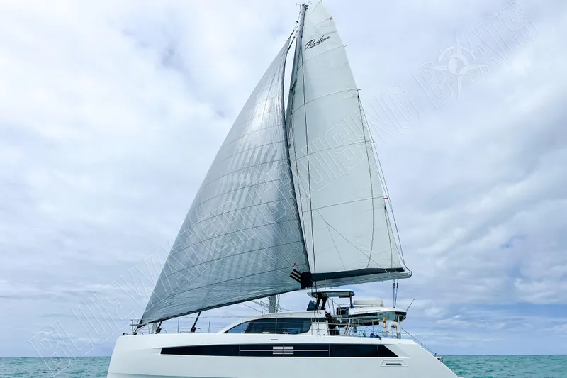 Fun Pass Yacht Photos Pics Sailing catamaran Privilege 580, 2025 model, cruising on open sea under cloudy skies.