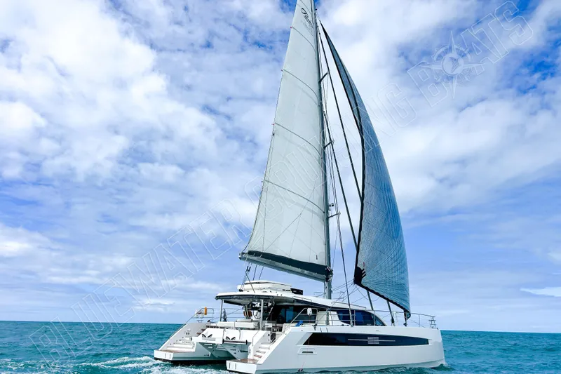 Fun Pass Yacht Photos Pics Sailing catamaran Privilege 580, 2025 model, cruising on open sea under clear skies.