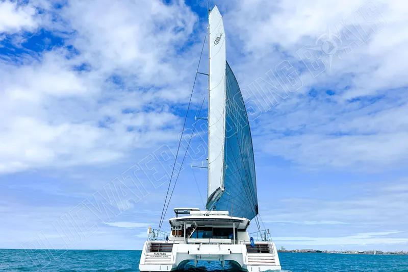 Fun Pass Yacht Photos Pics Sailing catamaran Privilege 580, 2025 model, cruising on open sea under blue sky.