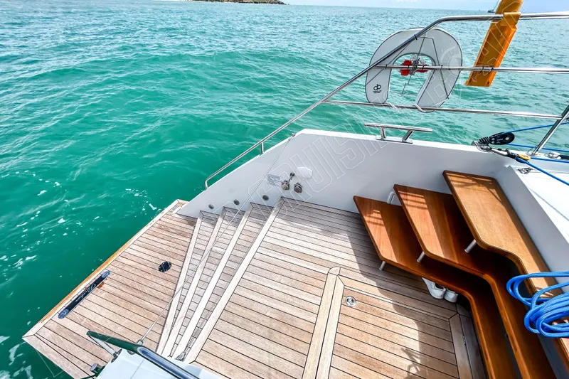 Fun Pass Yacht Photos Pics Luxury yacht Privilege 580, 2025 model, featuring elegant wooden deck and steps by the sea.